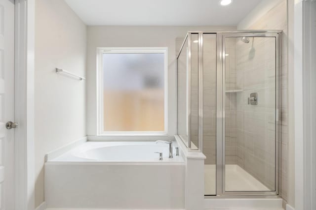 bathroom with separate shower and tub