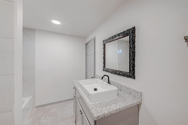 bathroom with tile patterned floors and vanity