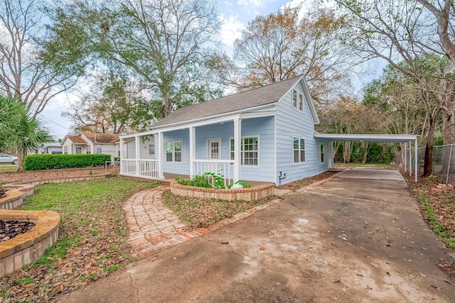 view of side of home with a carport and covered porch