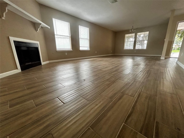 unfurnished living room featuring an inviting chandelier