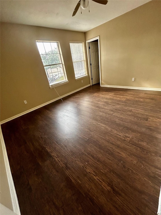 unfurnished room featuring dark hardwood / wood-style floors and ceiling fan