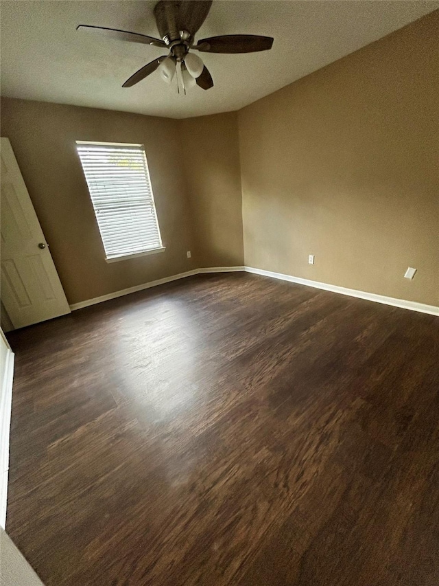 spare room with ceiling fan and dark hardwood / wood-style flooring