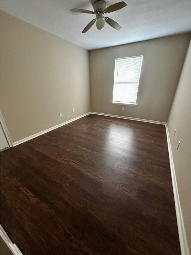 spare room featuring ceiling fan and dark hardwood / wood-style floors