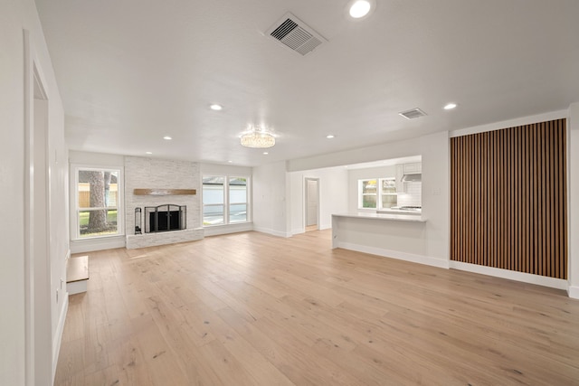 unfurnished living room featuring light hardwood / wood-style floors and a fireplace