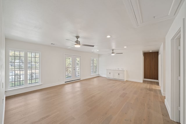 unfurnished living room featuring light hardwood / wood-style floors and ceiling fan