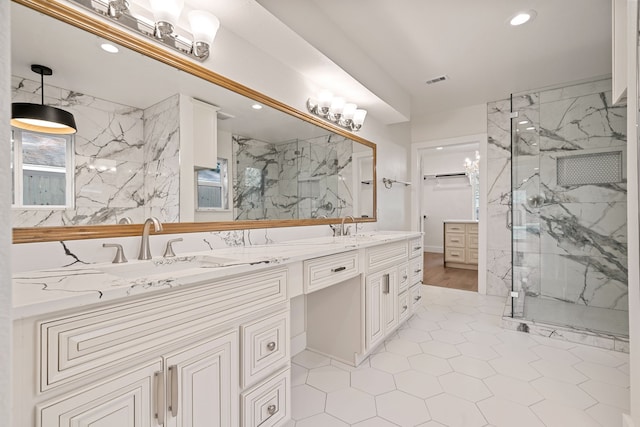 bathroom with tile patterned floors, vanity, and a shower with door