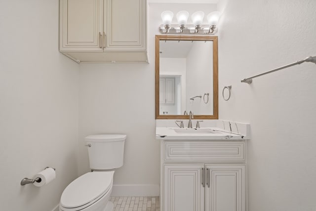 bathroom with tile patterned flooring, vanity, and toilet