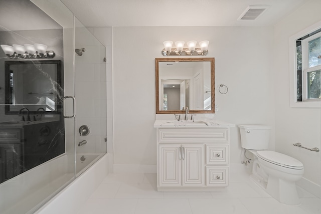 full bathroom featuring tile patterned floors, vanity, toilet, and bath / shower combo with glass door