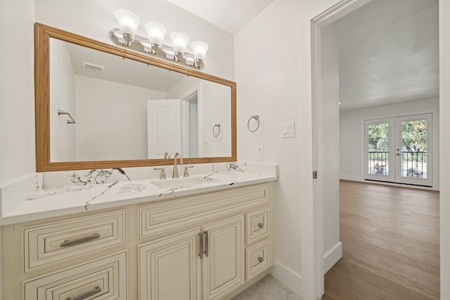 bathroom featuring french doors and vanity