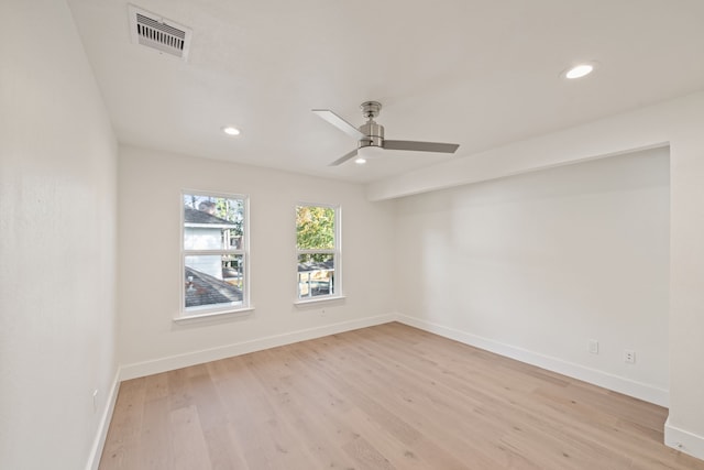 empty room with ceiling fan and light wood-type flooring