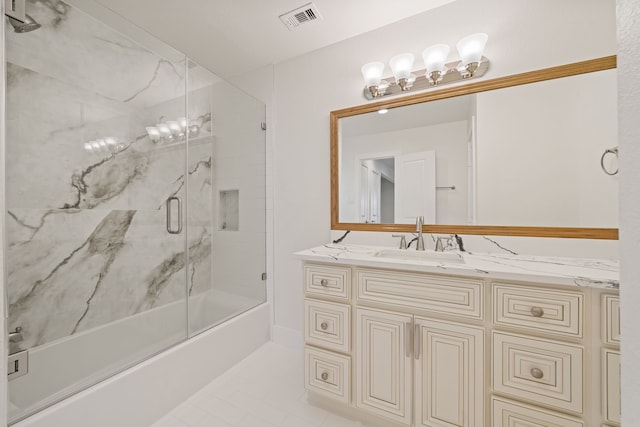 bathroom featuring combined bath / shower with glass door, vanity, and tile patterned floors