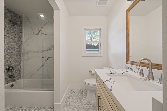 full bathroom featuring tile patterned flooring, toilet, vanity, and tiled shower / bath