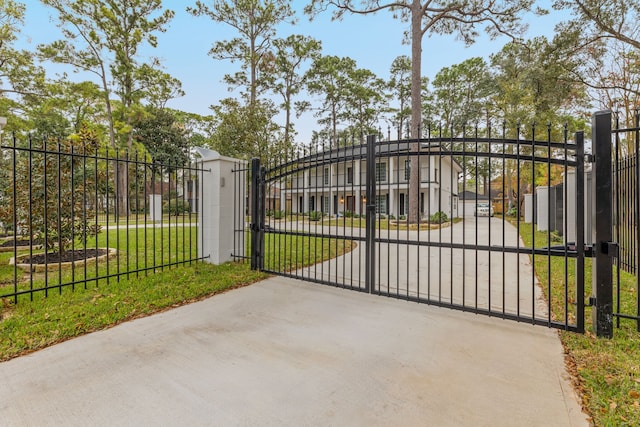 view of gate featuring a yard