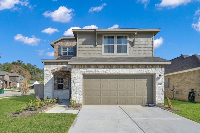 view of property featuring a garage and a front lawn