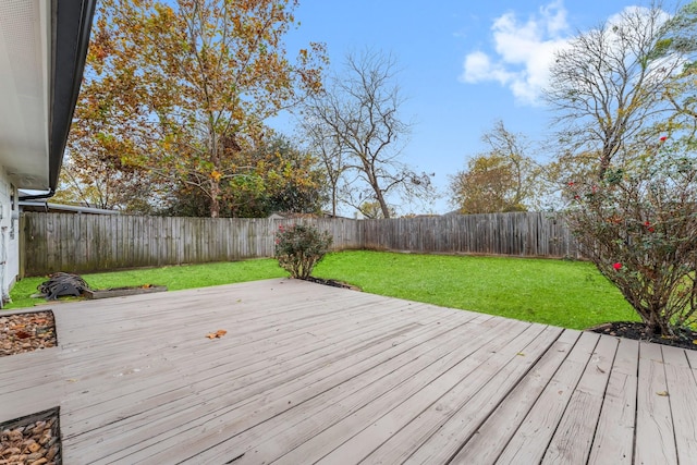 wooden deck featuring a lawn