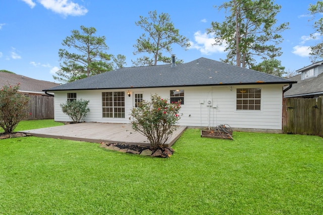 rear view of property with a yard and a deck