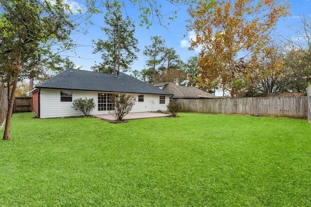 rear view of property with a lawn and a patio area