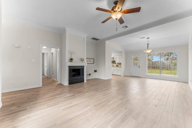 unfurnished living room featuring light hardwood / wood-style flooring, ceiling fan, and crown molding