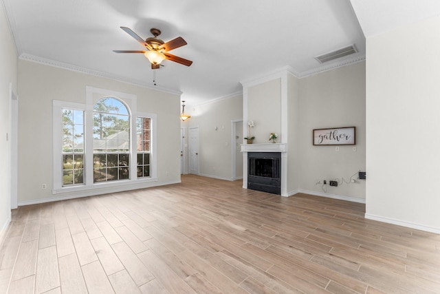 unfurnished living room featuring light wood-type flooring, ceiling fan, and ornamental molding