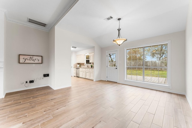 unfurnished living room with vaulted ceiling and light hardwood / wood-style flooring