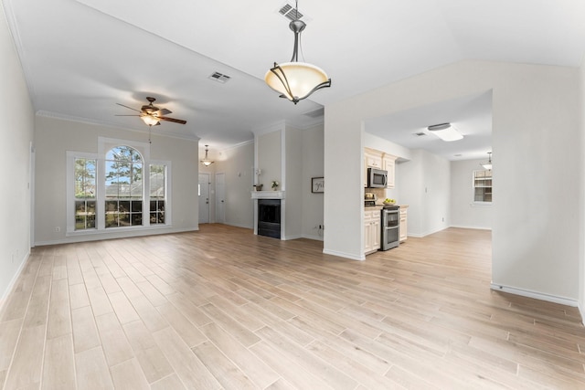 unfurnished living room featuring light hardwood / wood-style floors, ceiling fan, and crown molding