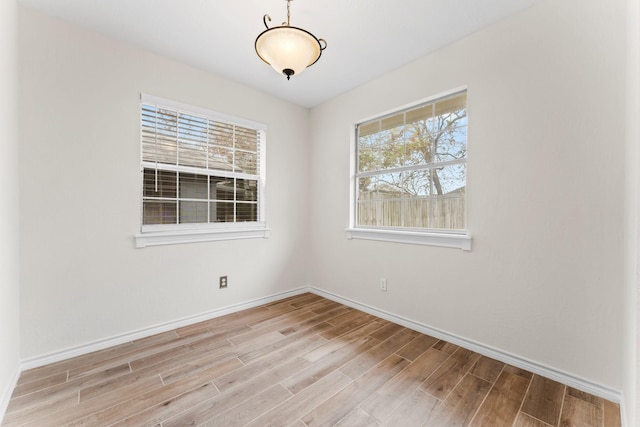 spare room with light hardwood / wood-style flooring