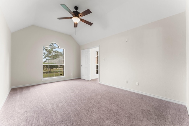 spare room featuring light colored carpet, ceiling fan, and lofted ceiling