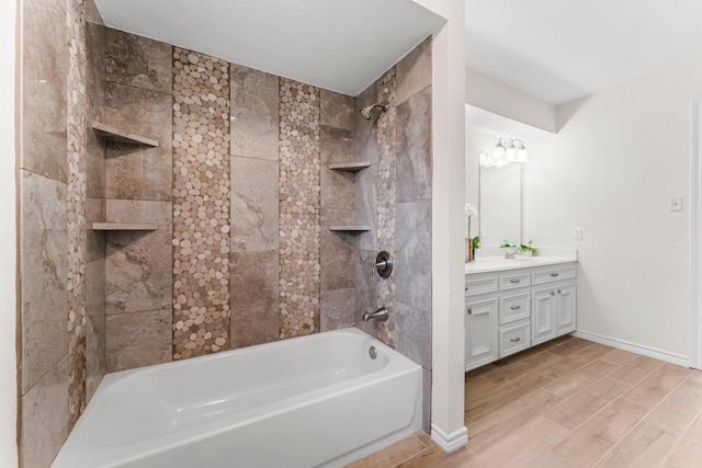 bathroom with vanity and tiled shower / bath