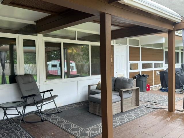 sunroom / solarium with beamed ceiling and plenty of natural light