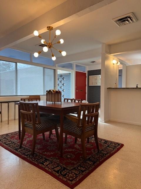 dining space with a notable chandelier