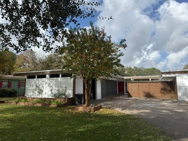 rear view of house with a lawn