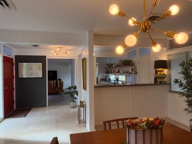 kitchen with kitchen peninsula and a notable chandelier