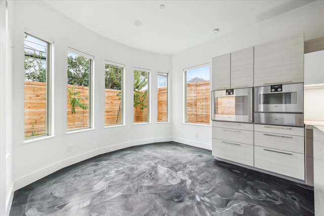 unfurnished sunroom with a wealth of natural light