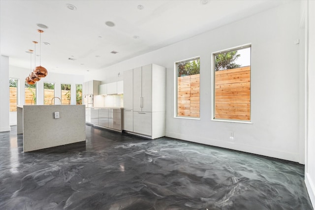 unfurnished living room featuring a healthy amount of sunlight