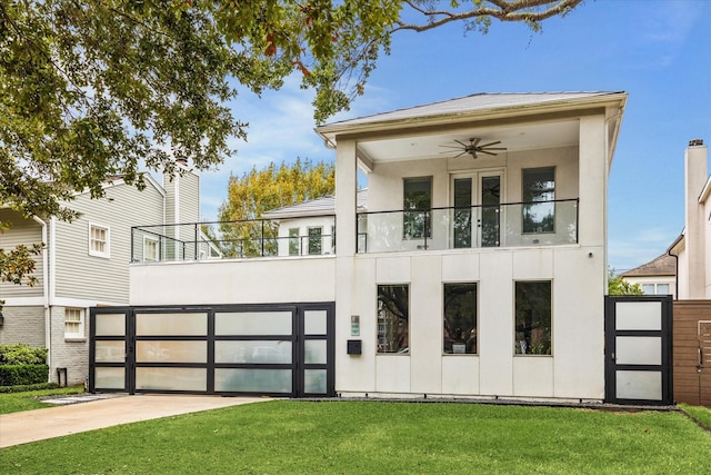 modern home featuring a front lawn, a balcony, and ceiling fan