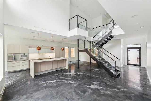 interior space featuring sink and a high ceiling