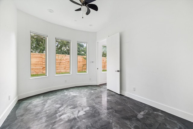 unfurnished room featuring ceiling fan and a healthy amount of sunlight