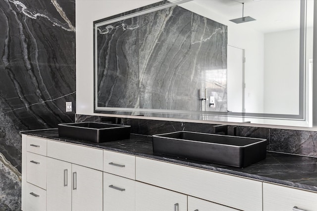 bathroom with decorative backsplash and vanity