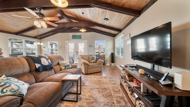 living room with french doors, ceiling fan with notable chandelier, light hardwood / wood-style flooring, wooden ceiling, and vaulted ceiling with beams