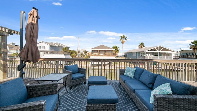 deck with outdoor lounge area and a water view