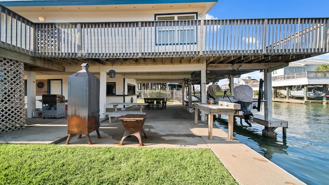 view of patio / terrace with a deck with water view, a dock, and area for grilling