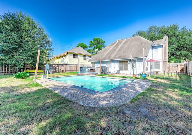 view of pool with a lawn