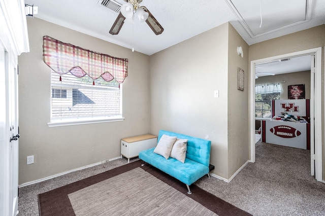 sitting room with carpet floors, plenty of natural light, and ceiling fan