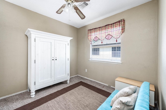 unfurnished bedroom featuring dark colored carpet and ceiling fan