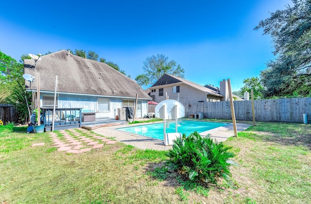 view of swimming pool with a yard and a patio