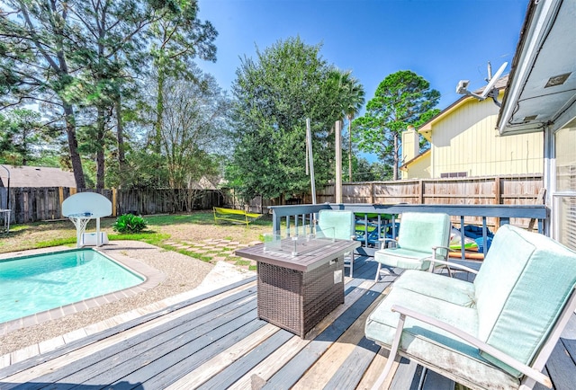 deck featuring a lawn and a fenced in pool