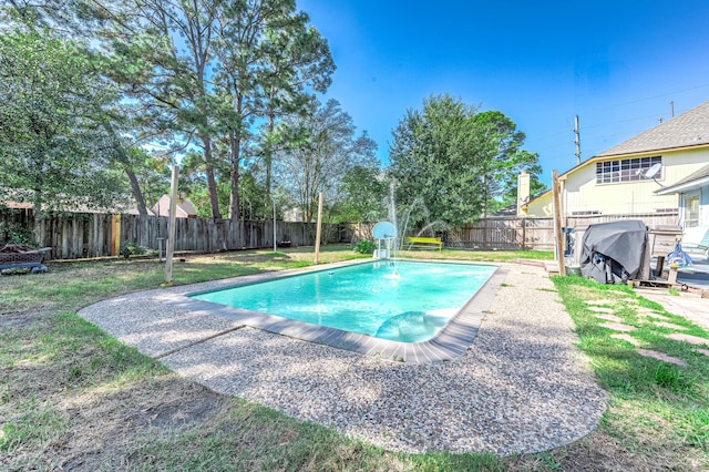 view of pool featuring a lawn