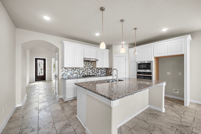 kitchen featuring a kitchen island with sink, white cabinetry, sink, and appliances with stainless steel finishes