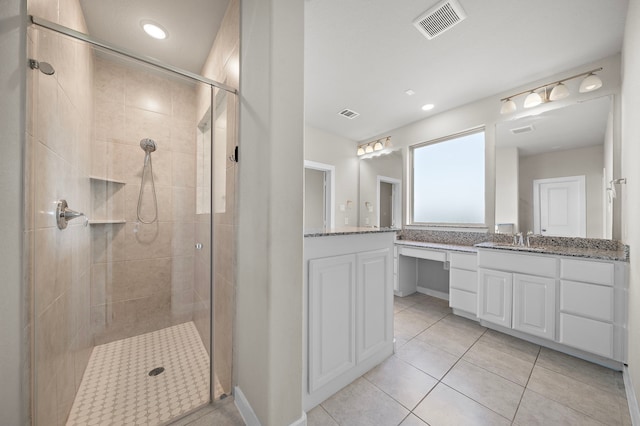 bathroom with tile patterned flooring, vanity, and an enclosed shower