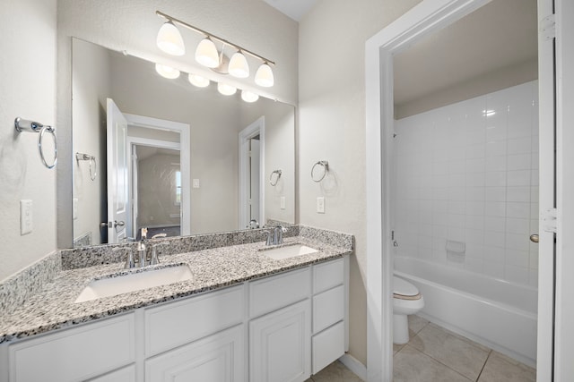 full bathroom with tile patterned floors, vanity, toilet, and tiled shower / bath combo